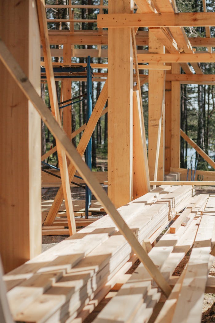 about-us-img Sunlit construction site with wooden lumber arranged in rows. Perfect for building projects.