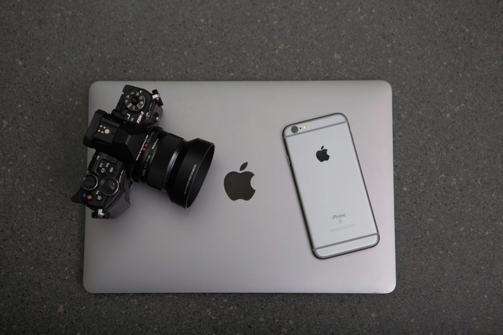 pexels photo 306763 306763 High-angle shot of DSLR camera, MacBook, and iPhone on textured surface, showcasing modern technology essentials.